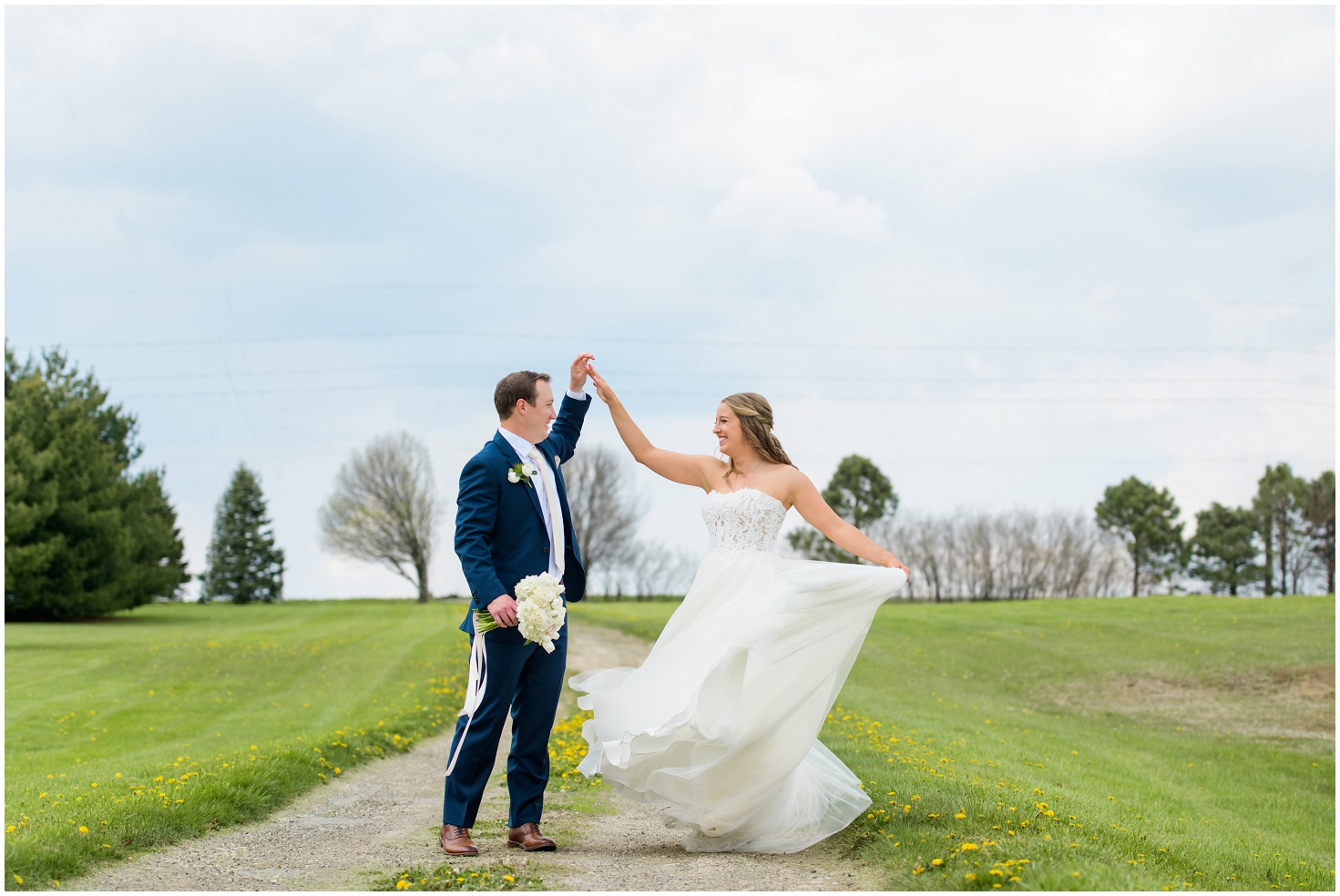 Image from an Iowa Wedding Photographer of couple dancing in the sunlight